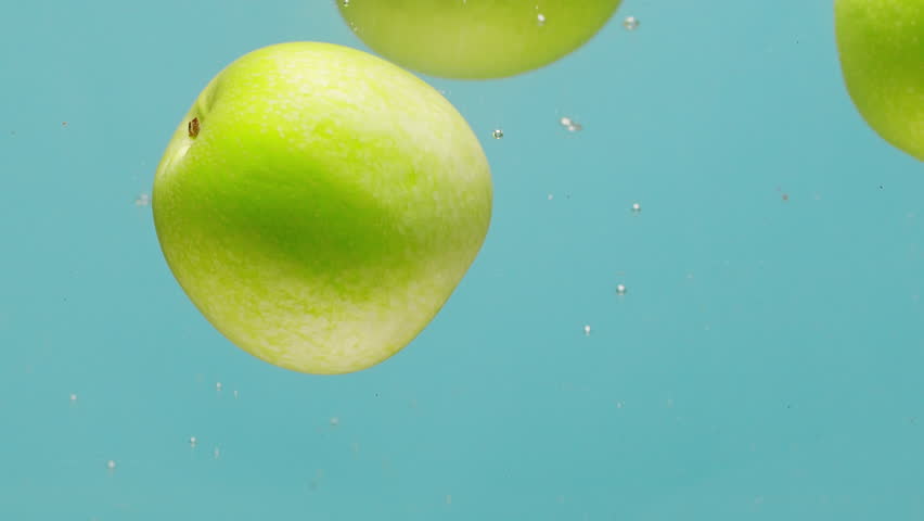 Green apple falling in boiling water, fresh sliced fruits and vegetables falling splashing into water aquarium or pot, splash healthy food diet freshness concept.  - Powered by Shutterstock - Get 15% off with code: PIKWIZARD15
