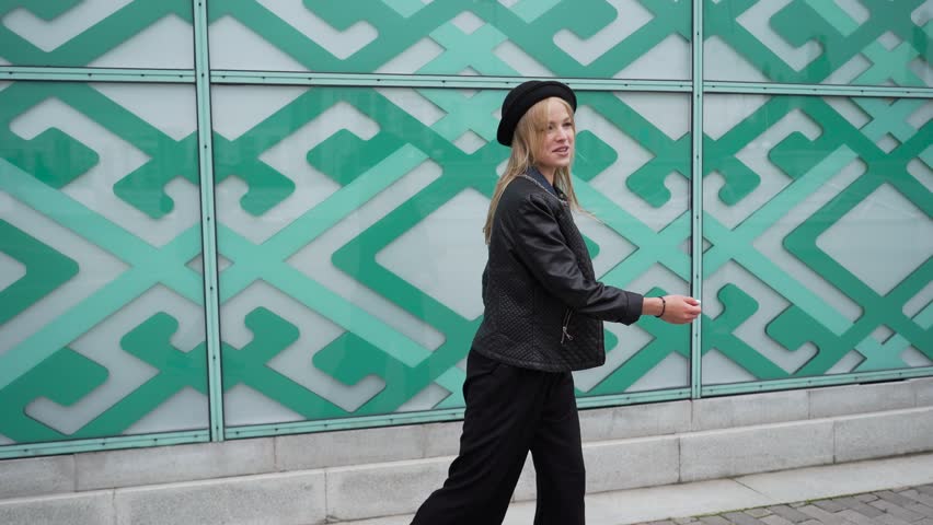Young woman rejoicing and jumping on the street