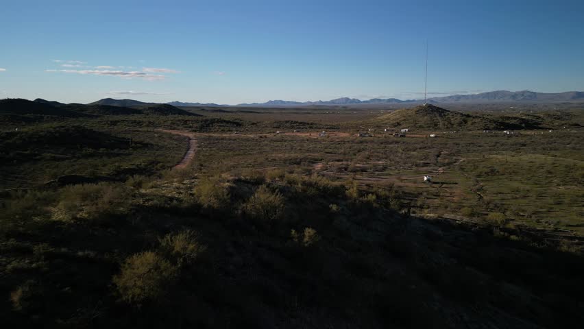Aerial of RVs camped in green desert in Wickenburg Arizona at sunset