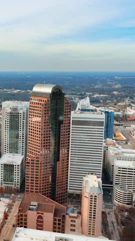 Aerial panoramic view of Charlotte, North Carolina city center with tall brown skyscraper of financial district. Vertical video.