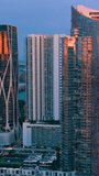 Aerial view of modern skyscraper building at evening Miami, Florida. Brickell city center. Vertical video.