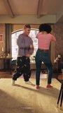 Vertical Screen: Stylish Diverse Multiethnic Couple in Cozy Clothes Recording a Dance Video from a Party at Home in Loft Apartment. Performing for Funny Viral and Active Video for Social Media App.