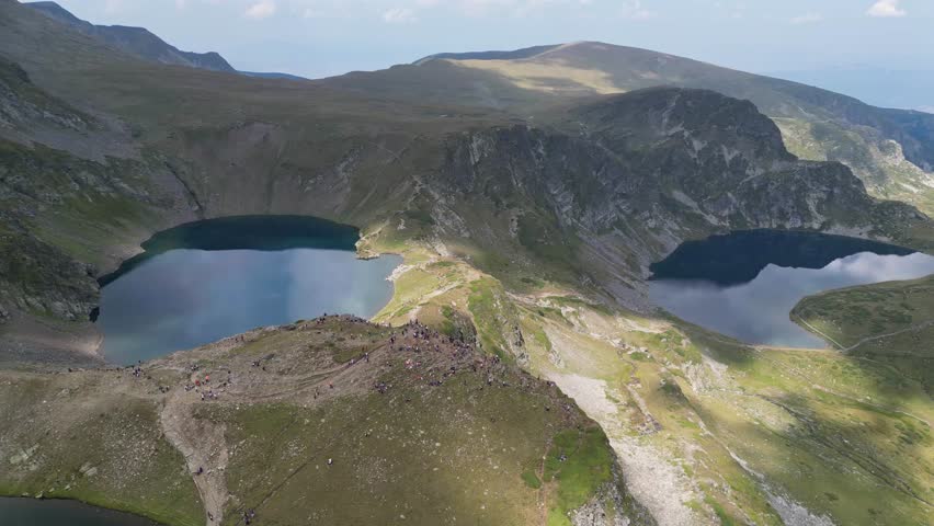 People at Seven Rila Lakes Hike Trail Viewpoint in Bulgaria - Aerial 4k Circling