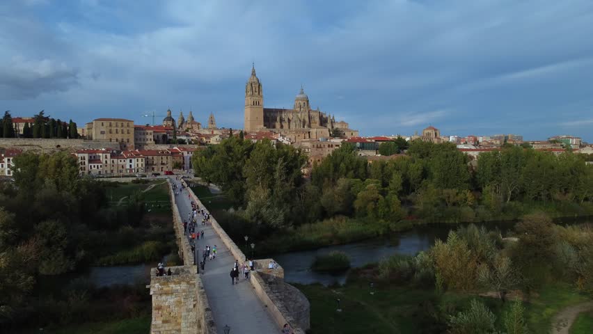 Aerial view of Salamanca with the cathedral in the background and the roman bridge in the foreground.
