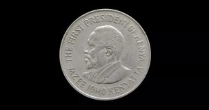 Obverse of Kenya coin 1 shilling 1978, isolated in black background. Seamless animation in 4k resolution video.