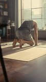 Vertical Screen: Fit Young Man Doing Core Strengthening Yoga Exercises and a Headstand During Morning Workout at Home in Sunny Apartment. Healthy Lifestyle, Fitness, Wellbeing and Mindfulness.