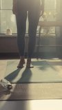 Vertical Portrait: Young Beautiful Female Holding Balance in Tree Yoga Pose in the Morning in Her Bright Sunny Loft Apartment. Healthy Lifestyle, Fitness, Wellbeing and Mindfulness Concept.