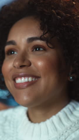 Vertical Portrait of the Black Happy Woman Smiling and Laughing at Something Funny while Sitting at the Evening Room. Blurred Background. Human Emotions Concept. Slow Motion Royalty-Free Stock Footage #3452307353
