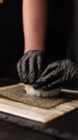 Japanese cuisine. the chef prepares rolls in the kitchen