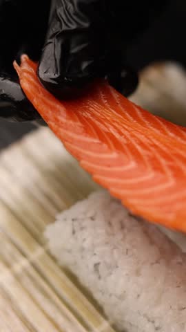 Japanese cuisine. the chef prepares salmon rolls in the kitchen
