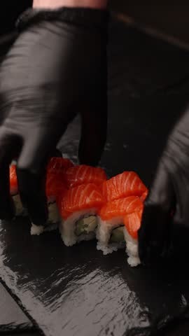 Japanese cuisine. the chef prepares salmon rolls in the kitchen