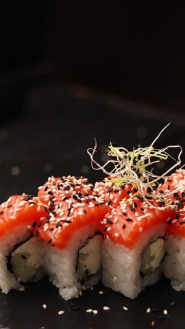 Japanese cuisine. the chef prepares salmon rolls in the kitchen