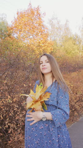 Beautiful pregnant woman having walk in the park