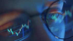 Trader wearing glasses is working on laptop computer. Screen with stock market charts and Bitcoin BTC or Ethereum ETH data analysis reflection. Broker trading online. Altcoins crypto currency trading - Powered by Shutterstock - Get 15% off with code: PIKWIZARD15