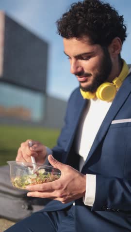 Businessman eating a healthy salad. Close-up view.