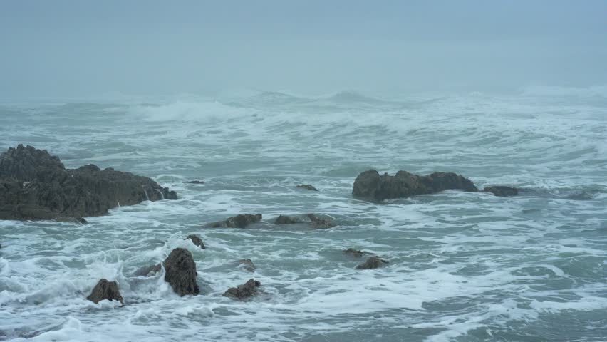 Grey, misty weather along the rocky Hermanus coastline. Whale Coast, Overberg, Western Cape, South Africa. Royalty-Free Stock Footage #3452402219