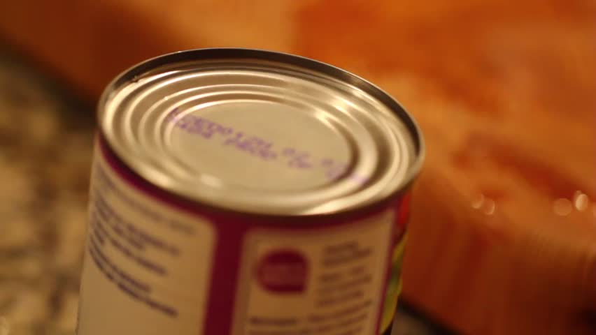 opening a can of beans with a can opener