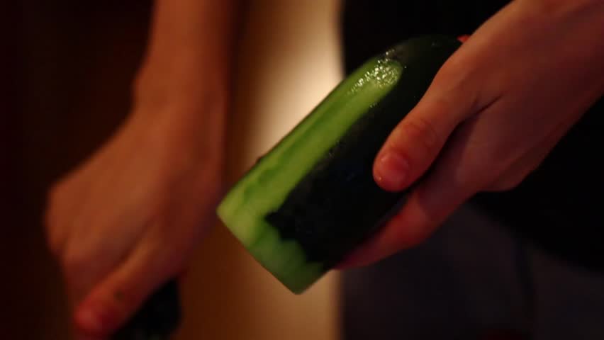 Peeling a cucumber for a spinach salad