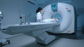 Patient in white clothes undergoes magnetic resonance imaging scan, laying down on bed for CT or PET scan, oncology machine scanning her body. Magnetic resonance diagnostics x-ray. - Powered by Shutterstock - Get 15% off with code: PIKWIZARD15