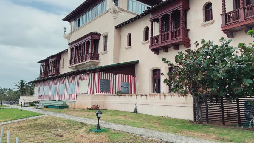 VARADERO, CUBA - DECEMBER 20, 2023: Dupont Villa, Xanadu Mansion, Dupont House. A beautiful building with a history, surrounded by palm trees on the ocean. The Atlantic coast of Cuba