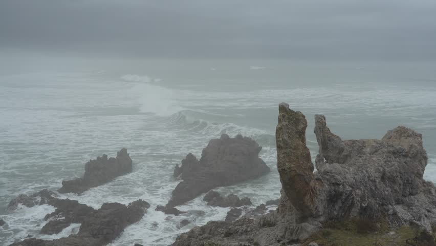 Grey, misty weather along the rocky Hermanus coastline. Whale Coast, Overberg, Western Cape, South Africa. Royalty-Free Stock Footage #3452503573