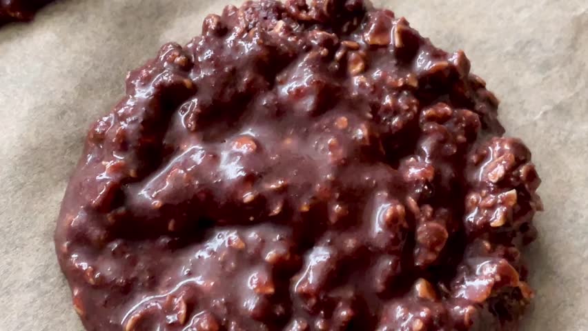 Baking sweet chocolate oat bisquits in the oven, homemade food recipe, slow motion video