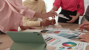 Designer team brainstorming and choosing color for graphic design working with client chromatic consultation based on customer demand for color design at designer agency office. Variegated - Powered by Shutterstock - Get 15% off with code: PIKWIZARD15