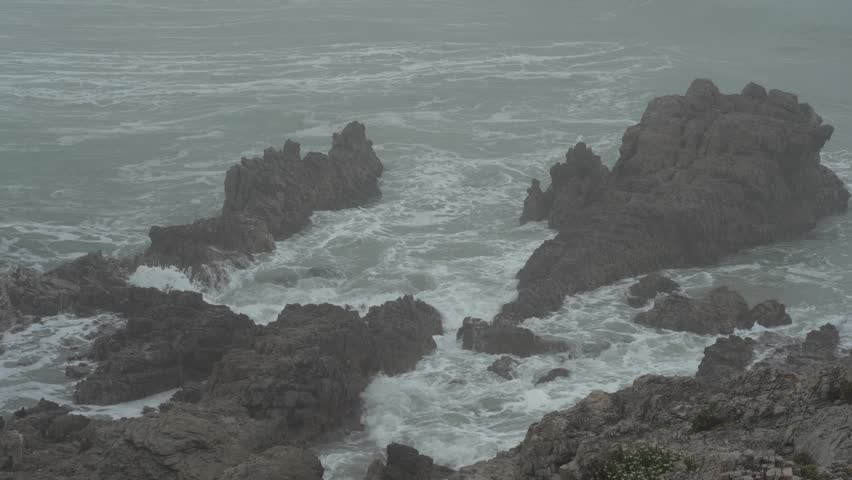 Grey, misty weather along the rocky Hermanus coastline. Whale Coast, Overberg, Western Cape, South Africa. Royalty-Free Stock Footage #3452569481