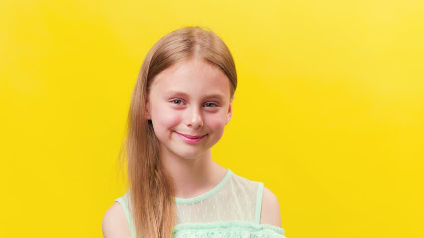 the portrait of a Caucasian child looking into the camera and smiling.