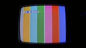SMPTE color bars with VHS effect. Effect retro TV with kinescope. Old CRT TV color rendering test with text - NO SIGNAL. TV Noise with interference.