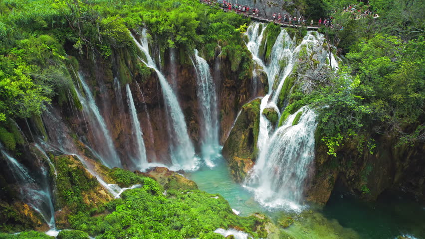 Plitvice waterfalls in Croatia. Distinct hues of blue and green can be seen in the cascades. Mountain streams flow into a lakes. Royalty-Free Stock Footage #3452644937
