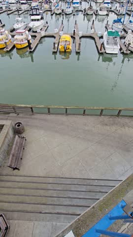 tilt footage of the boats and yachts docked in Fishermans Wharf with vast blue ocean water and powerful clouds in San Francisco California USA