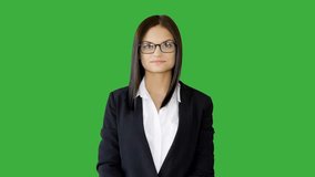Young Woman in Suit against Isolated Green Screen