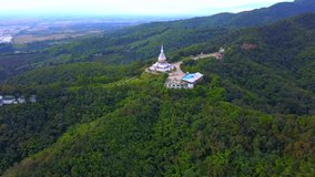 4K video resolution,Drone aerial view beautiful Thai temple over mountain at Northern Thailand with countryside top view beautiful nature landscape background.
