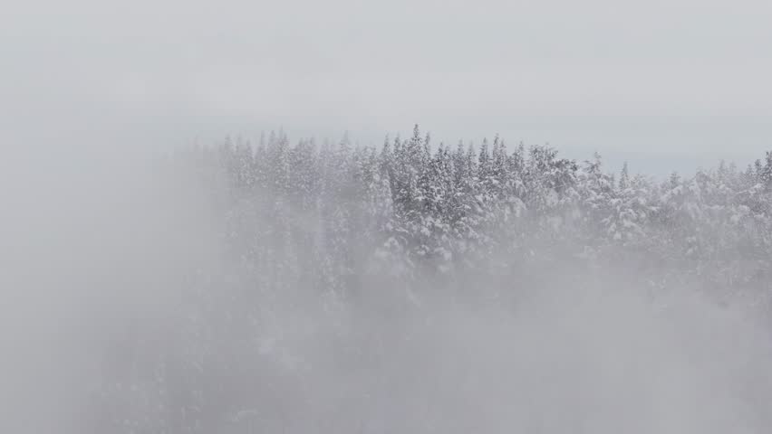 Drone footage: foggy snowy mountain scenery