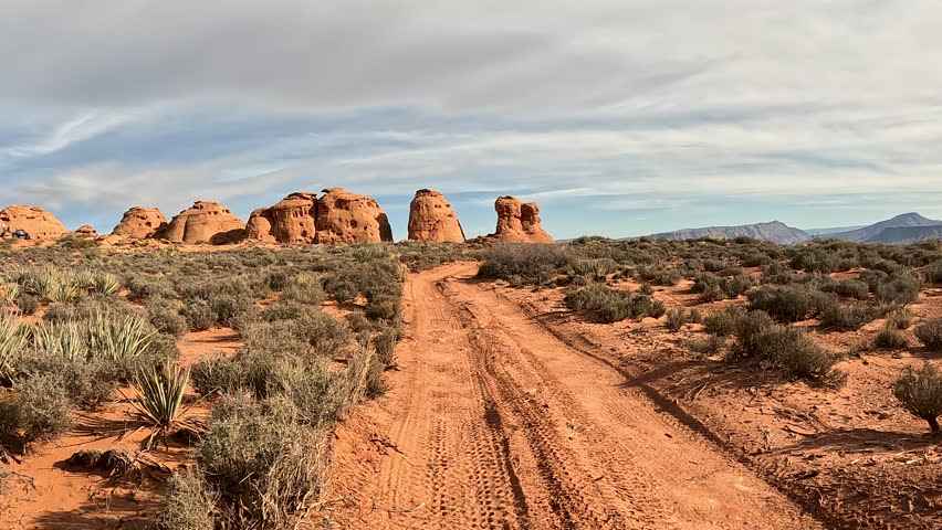 Off road 4x4 recreation rock pillars Utah POV. Southern Utah desert Sand Hollow. Red sandstone, dirt, sand trails. Outdoor extreme 4x4 recreation ride and adventure.