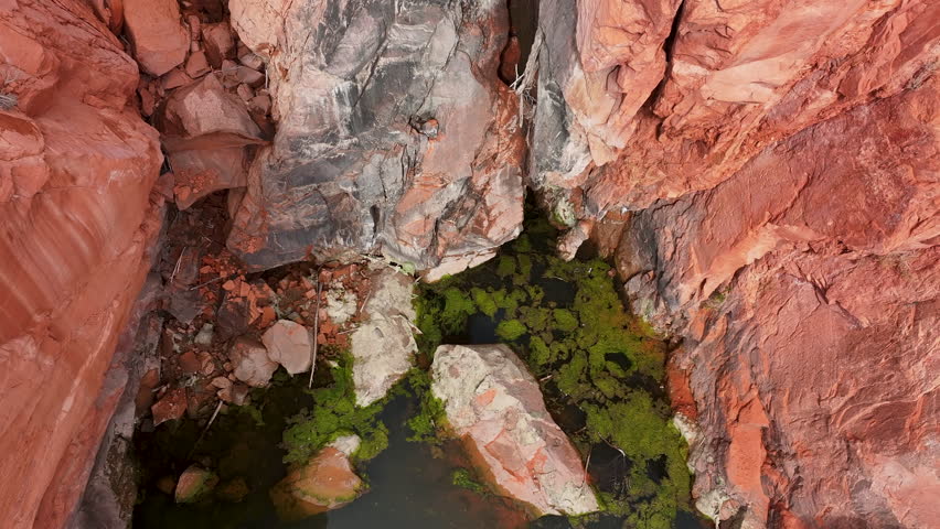 Aerial red rock Gunlock reservoir dry waterfall Utah climb 1. Gunlock State Park is a state park of Utah. Steep red rock sandstone and black volcanic landscape. Recreation hiking. Natural environment.