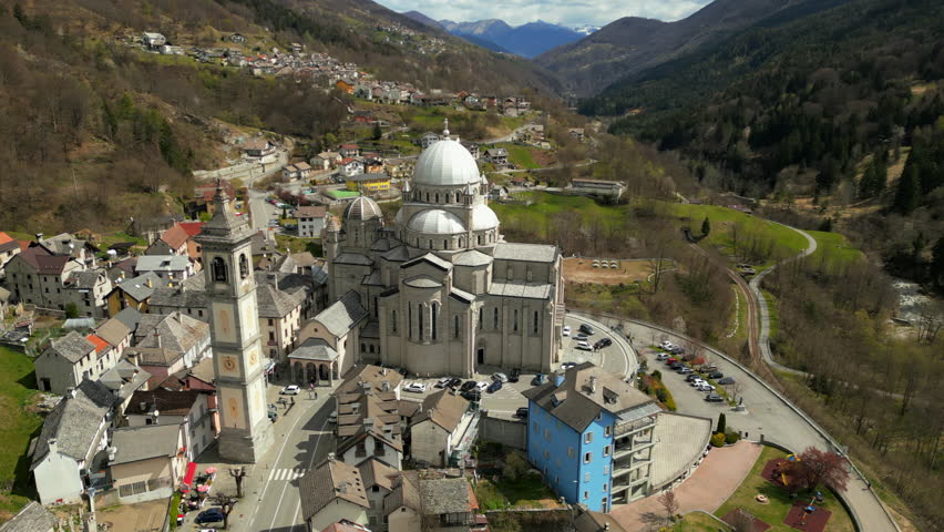 Aerial Summer view of alpine township The Santuario della Madonna del Sangue is a sanctuary in the comune of Re, Italy, 4K hi quality