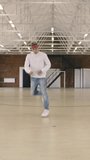 Male breakdancer dancing in sport gym. Vertical video