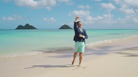 Extremely happy male tourist admiring the beauty of endless waters of tranquil ocean, raising hands with excitement, dreams come true, long awaited getaway. High quality 4k footage