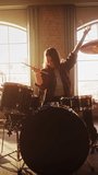 Vertical Screen: Beautiful Young Drummer Playing at a Band Rehearsal, Doing Tricks with Drumsticks. Learning Drum Solo on Drums and Cymbals in Sunny Living Room Loft Apartment