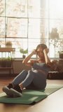 Vertical Screen. Portrait of a Beautiful Athletic Asian Woman Does ABS Crunches Exercises, Workout, Yoga, Stretching, Training at Home. Sunny Apartment with Positive Smiling Healthy Woman
