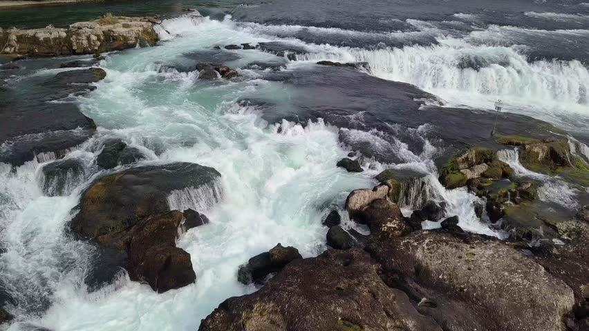 Crystal Clear Water Running through Stone Boulders