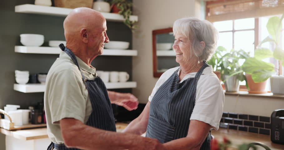 Senior, couple and hug in kitchen with love, support and care in marriage and retirement. Elderly, man and woman embrace with kindness or gratitude for cooking dinner in home together with happiness