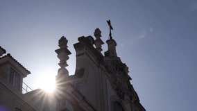 4K video with Church of Saint Dominic with direct sun getting out of this landmark building roof. Travel to Lisbon, Portugal.
