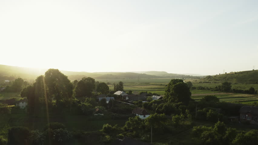 Golden Summer Sunset in a Distant Ukrainian Village with Ancient Trees and Rolling Hills