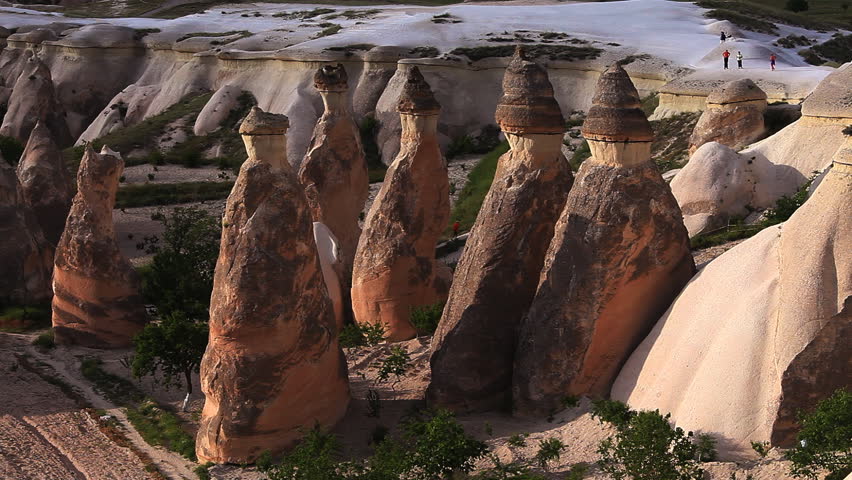 Picturesque rocks in Cappadocia with small figures of people on a background. Turkey. Canon 5D Mk II.