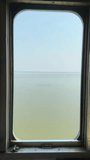 Vertical video view from window train running through scenic water reservoir.