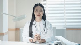 Doctor's Online Medical Consultation, young Asian female doctor talk on video call consult in white medical uniform and smiling at hospital, video conference call. medical nurse in Webcam