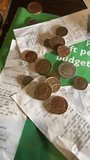 bills receipts and coins money during credit crisis struggle with money concept UK